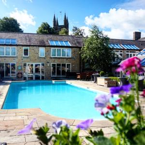 a swimming pool in front of a building at Feversham Arms Hotel & Verbena Spa in Helmsley