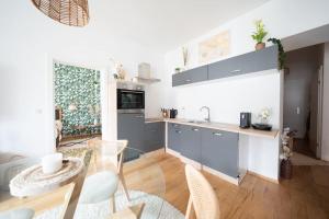 a kitchen with a table and chairs in a room at BOHO Dream Apartment in Vienna