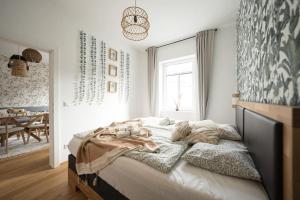 a bedroom with a large bed with blankets on it at BOHO Dream Apartment in Vienna