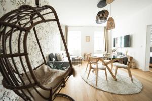 a living room with a chair and a table at BOHO Dream Apartment in Vienna