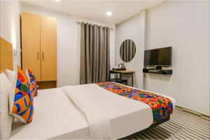 a hotel room with a bed and a tv at FabHotel Chawla House in New Delhi