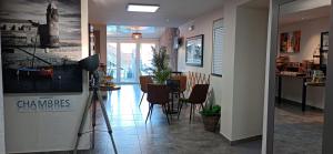 a hallway with a dining room and a dining table at Hotel Le Majestic Canet plage in Canet-en-Roussillon