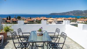 a blue table and chairs on a balcony with a view at Stella Rooms in Kardamili