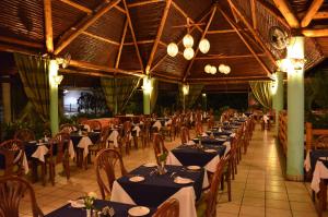 a dining room with tables and chairs in a restaurant at Travellers Beach Hotel in Mombasa