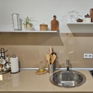 a kitchen counter top with a sink and a counter top at Moonrise Apartment in Mostar +17 photos