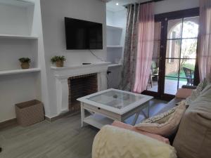 a living room with a couch and a fireplace at Sonsoles Apartamentos Bahía Sur in San Fernando