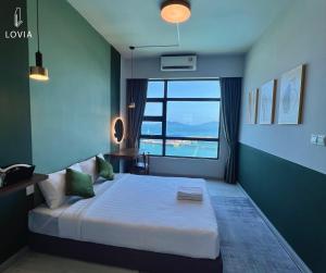 a bedroom with a large bed with a large window at Jesselton Quay KK SEA VIEW or CITY VIEW by LOVIA in Kota Kinabalu