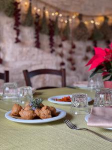 a table with two plates of food on a table at Tenuta Tedone Consolini in Ruvo di Puglia