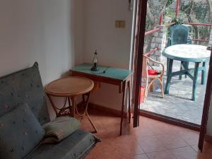 a living room with a table and a chair at Apartments Rudi in Klenovica