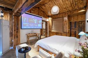 a bedroom with a bed and a large screen at No.5 Valley Lodge in Zhangjiajie