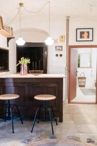 a kitchen with two stools in front of a counter at Hiša Borov Gaj in Mojstrana