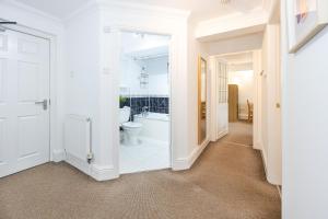 a white bathroom with a toilet and a sink at The Burton- Free Gated Parking in Manchester +86 photos