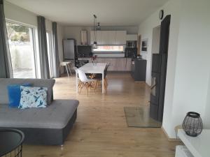 sala de estar y cocina con sofá y mesa en Lipnohaus en Horní Planá