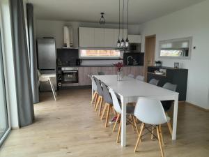 a kitchen and dining room with a white table and chairs at Lipnohaus in Horní Planá +47 photos