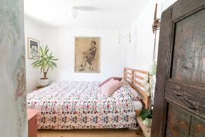 a bedroom with a bed with a floral bedspread at Hiša Borov Gaj in Mojstrana