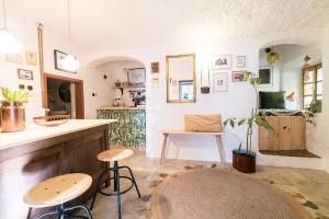 a room with two stools and a counter and a table at Hiša Borov Gaj in Mojstrana