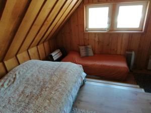 a bedroom with two beds in a wooden cabin at Lili’s Holiday House in Otepää