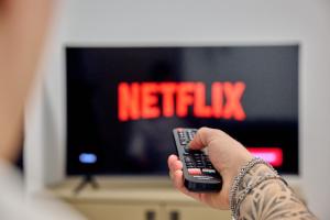 a person holding a remote control in front of a television at Cà del Lasco - Modern Apartments in Classic Villa in Bellano