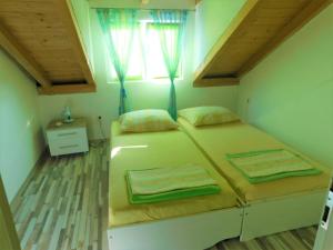 a bedroom with two beds and a window at Nautica in Murter