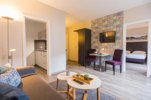 a living room with a couch and a table at aparthotel Cochem in Cochem