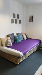 a futon with a purple blanket on it in a room at Exklusive Ferienwohnung Lurelei 150 qm mit Traumblick 4 bis 9 P in Bacharach