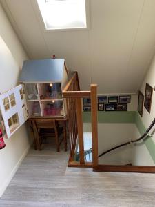 a attic room with a lamp and a window at Rose Cottage B&B in Nes