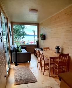 a living room with a table and chairs and a large window at Mazury Glamping in Orzysz