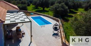 an overhead view of a swimming pool next to a house at Tania's Villa in Dorizata village! in Dhorizáta