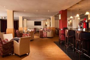 a restaurant with a bar and some chairs and tables at Ona Marinas de Nerja Spa Resort in Nerja