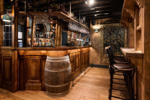 a bar with a barrel in the middle of a room at The Swan at Grasmere- The Inn Collection Group in Grasmere