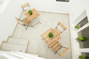 an overhead view of two chairs and tables with plants at Los Alonsos - Open Mall in Arrecife