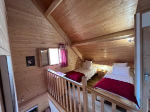 a room with two beds in a log cabin at Chalet des Monts Dore in Chastreix