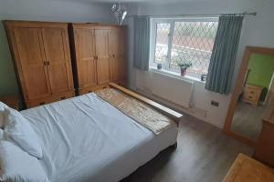 um quarto com uma cama e uma janela em GOLF OPEN HOYLAKE Bungalow In West Kirby em West Kirby