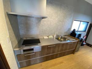 a kitchen with a sink and a stove at FTH Moon Light 3min to Sta. in Shimo-yoshida +24 photos