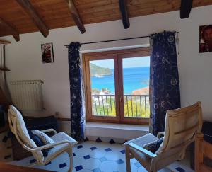 a room with a window with a view of the ocean at Palinuro Romantic panoramico al centro del paese in Palinuro