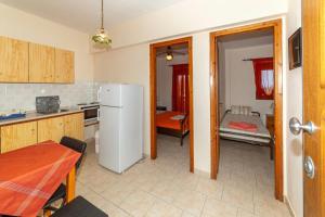 a kitchen with a white refrigerator and a table at Pension Veria Frankfurt in Akti Salonikiou +20 photos