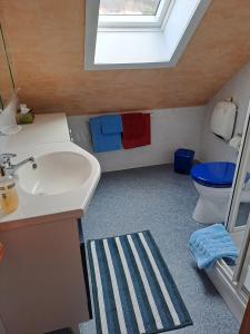 a bathroom with a sink and a toilet and a window at Ferienwohnung-Pruemtalblick in Prüm