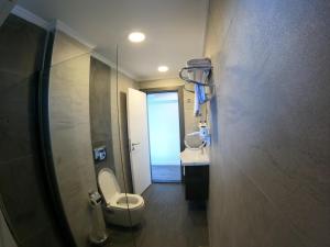 a bathroom with a toilet and a sink and a mirror at avsa extra vagant hotel in Avşa Adası