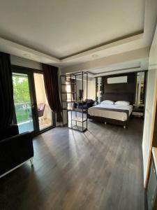 a large bedroom with a bed and a large window at avsa extra vagant hotel in Avşa Adası