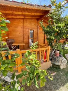 a wooden cabin with a table and a bench at Cilek Butik Hotel in Cesme
