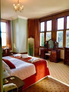 A bed or beds in a room at Purbeck House Hotel & Louisa Lodge