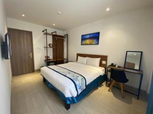 Postel nebo postele na pokoji v ubytování Essenza Hotel Đà Nẵng