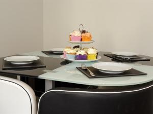 a table with cupcakes and plates on top of it at Blue Star House in Portsmouth