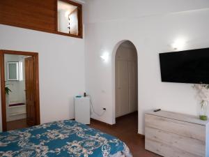 a bedroom with a bed and a flat screen tv at Residencial Art Brut in Castellón de la Plana