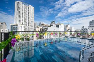 a swimming pool on the roof of a building with buildings at Samatha Apartment & Hotel in Da Nang