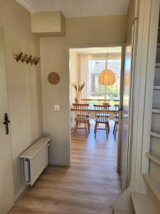 a hallway with a dining room with a table at Bohemian Wellness met hottub & sauna in Ewijk