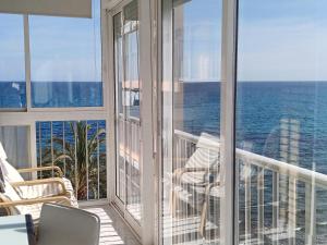 a balcony with a view of the ocean at Apartamento Cabo Azul Playa Campello in El Campello