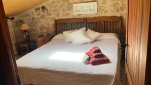 a bedroom with a bed with a towel on it at La gallina in Arnés