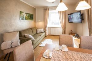 a living room with a couch and a table at Appartements am Landschaweg in Weiz