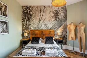a bedroom with a bed and a wall with a mural at luxury Villa Marie Emeraude Paris Orly Jacuzzi in Draveil